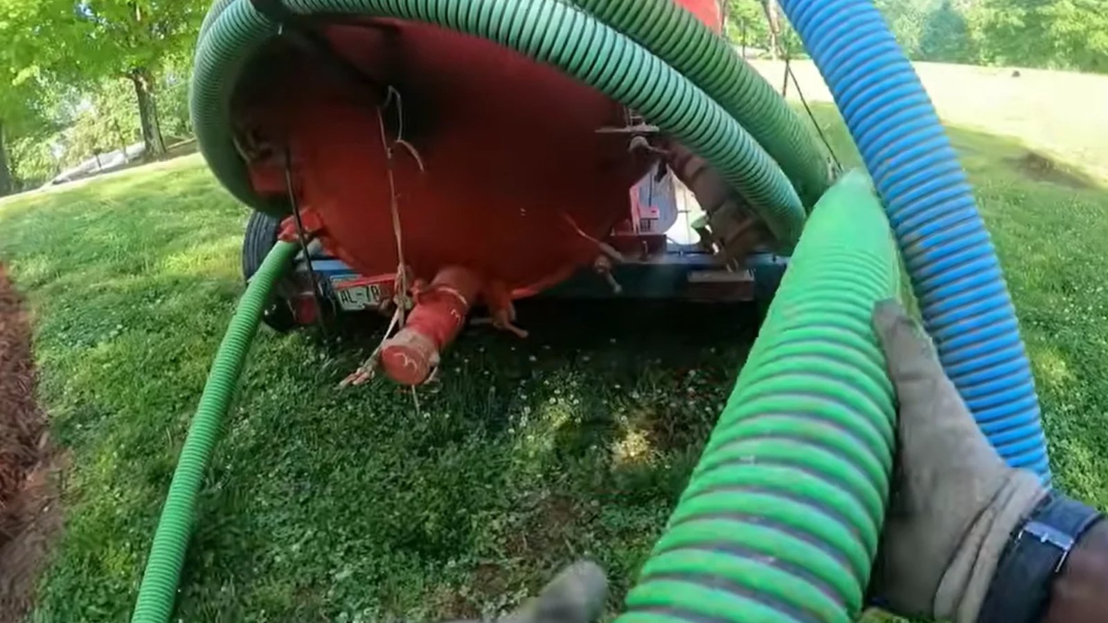 Septic service truck pumping a residential septic tank in Naples, FL